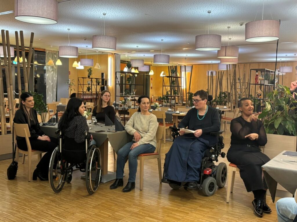 mehrere Frauen sitzen in einem Seminarraum auf Stühlen