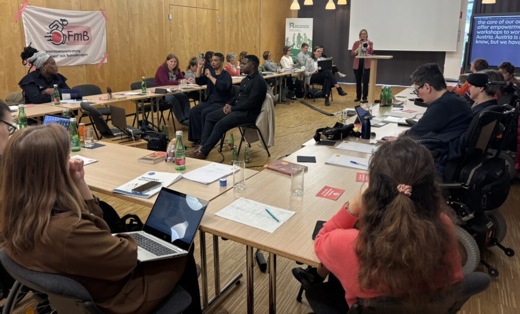 mehrere Frauen sitzen in einem Seminarraum auf Stühlen, während eine Frau stehend spricht