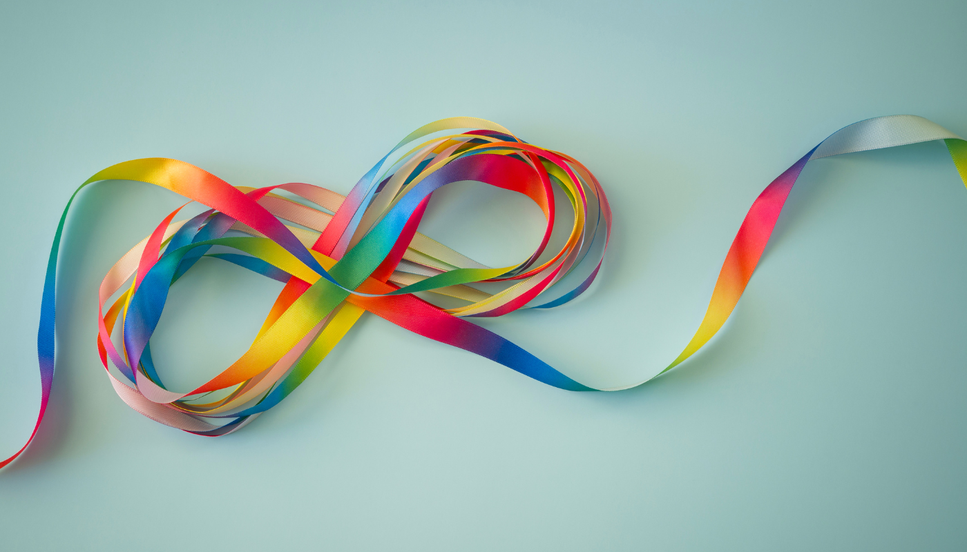 Ein Unendlichkeitssymbol, das aus regenbogenfarbenem Papier gebildet wird.